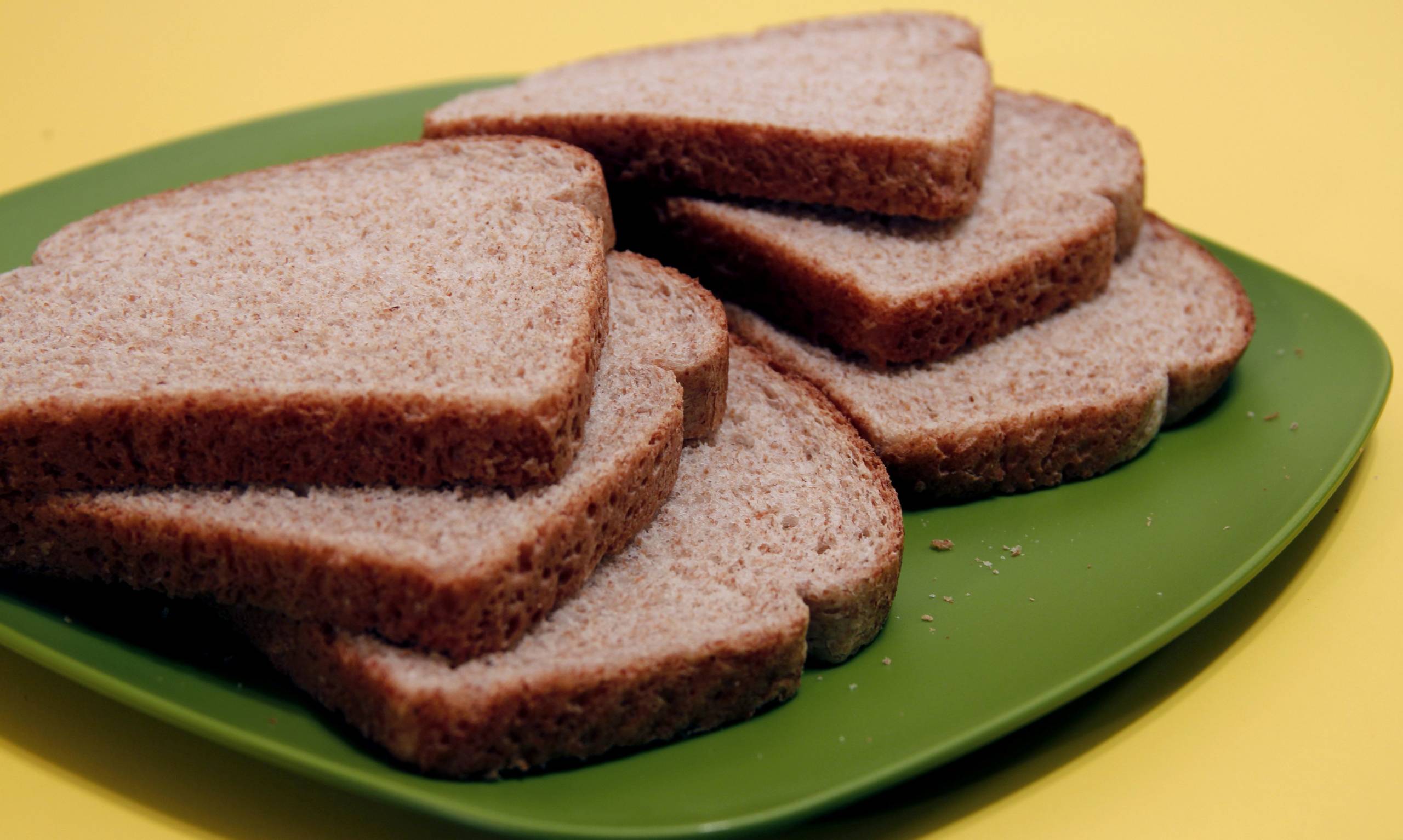 Six slices of whole wheat bread that had been set atop a green p